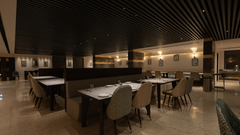 A spacious dining area at Pride Resort, Jodhpur, with tables and chairs arranged under warm, ambient lighting.