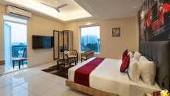 Premium room with stylish decor and city-facing window at Rivido - Manyata