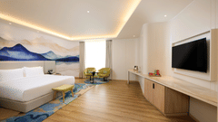 Deluxe room at Riviera Sarovar Portico, Pathankot with comfortable bedding, modern furniture and soothing decor for a restful stay.