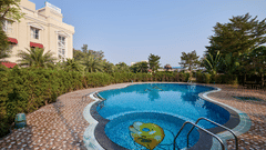 the two swimming pools at Royal Kingdom Sarovar Portico, Pilibhit, with the kiddie pool in the foreground and the full sized pool in the background