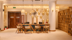 Reception area of the hotel with a desk and cosy seating, adorned with warm lighting - Royal Tulip, Chitwan