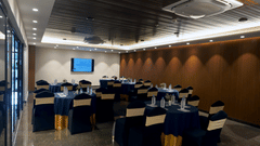 tables arranged in a cluster seating arrangement inside Conclave, the boardroom at Sarovar Portico, Kolkata Rajarhat