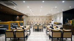 a chef standing inside Golpo all-day dining at Sarovar Portico, Kolkata Rajarhat 