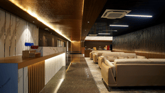 red and blue drinks kept on a shelf beside sofas in the lounge at Sarovar Portico, Kolkata Rajarhat