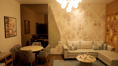 Sitting area at Sarovar Portico, Somnath with sofas, round tables, wall art, and a ceiling light fixture.