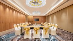 A long conference table in a room at Sarovar Premiere Alwar with chairs arranged for a meeting.