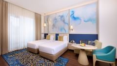 A twin bedded hotel room in amritsar with a carpet and cosy furniture - Sarovar Premiere, Amritsar