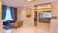 A tiled lobby at our hotel with cosy seating area and warm lighting - Sarovar Premiere Amritsar