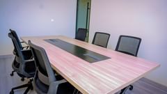 A boardroom in Hargeisa featuring a sleek wooden table and ergonomic chairs - Serene Sarovar Premiere Hargeisa