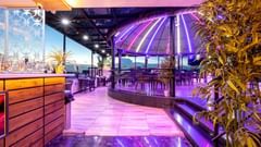 A side view Sudaka dome with vibrant lights - The Saibaba Hotel