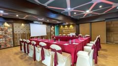 Swayam hall with lots of chairs - The Saibaba Hotel