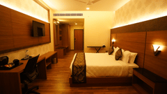 EXECUTIVE KING with a double bed, television mounted on the wall, desk with chair, wooden flooring, lighting, and wall decor at V FIVE HOTEL.