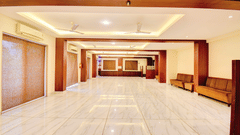 Grand banquet hall with elegant lighting and reception counter at VITS Lonavala.