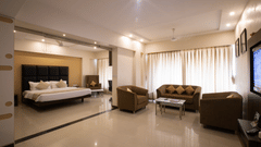 An overview of the suite with a king bed, sofas and a coffee table in view - VITS Shalimar, Ankleshwar.