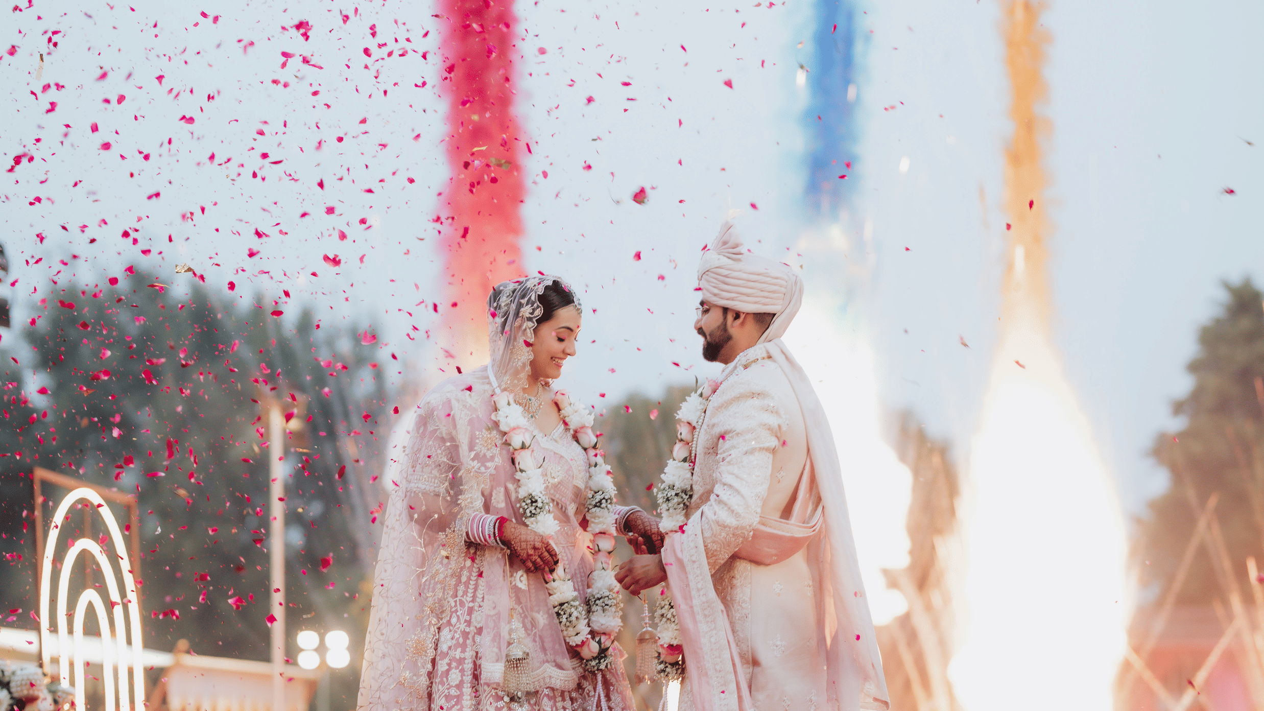 Couple performing wedding rituals with fireworks and vibrant colours at Umaid Palace