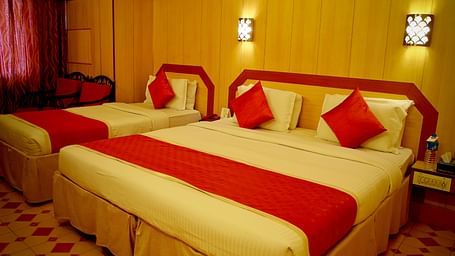 a view of a room furnished with a double bed and a single bed - Hotel Swagath, Bangalore