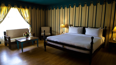 A spacious bedroom with a large bed and a sofa