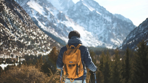 A person hiking in a snowy mountain landscape.