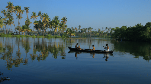 FIshermen fishing on a small boat in the middle of a lake
