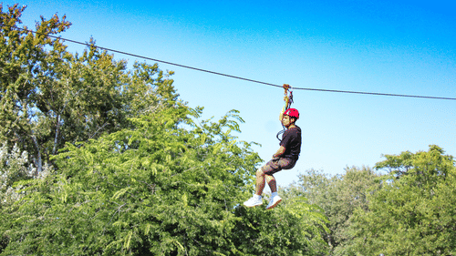 a person ziplining during daytime