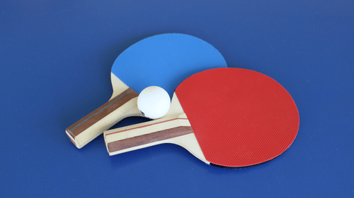 Adamo the Bellus - two table tennis rackets and a ball kept on the table
