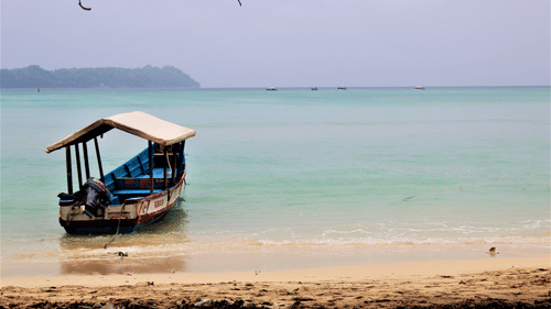 a boat on a beach at Neil Island 