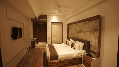 Suerior room with king size bed, side table and LED TV at Classic Sapphire by Ananta