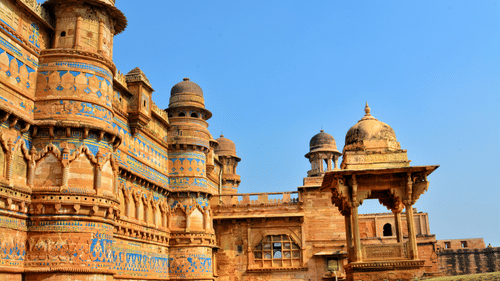 Facade of Gwalior Fort under a clear sky on a sunny day