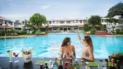 Two women at the Pool Sunken Bar at Heritage Village Resort & Spa, Goa