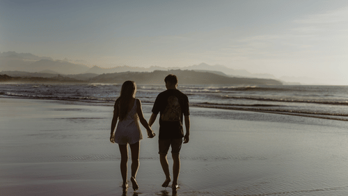 A couple walking along a beach