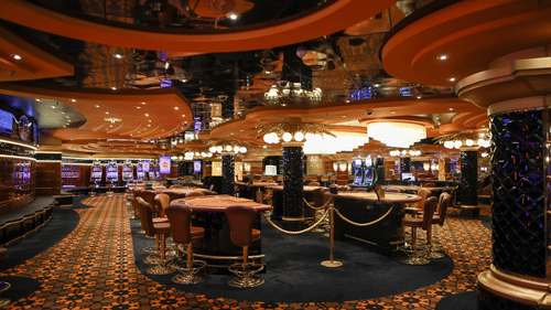 Elegant casino gaming floor with tables and ambient lighting in Goa.