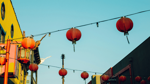 An overview of lanterns hung on the streets connected by a rope