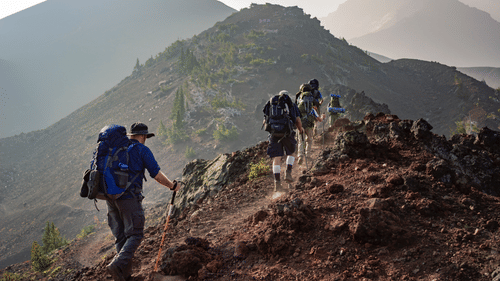 A person trekking over a hill