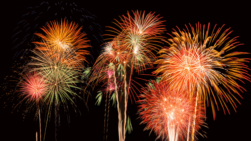 fireworks lighting up the night sky with different colours as seen from below