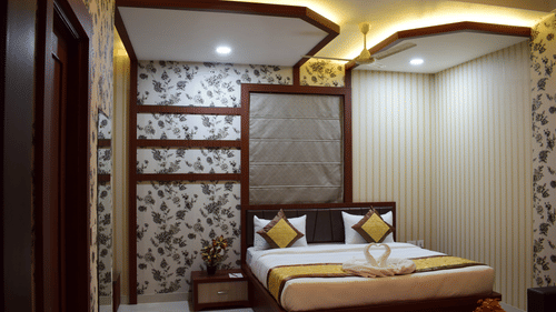 A modern luxury hotel bedroom in Varanasi, showcasing elegant decor, ambient lighting, and comfortable furnishings available through exclusive Varanasi hotel deals - Hotel Uday Palace.