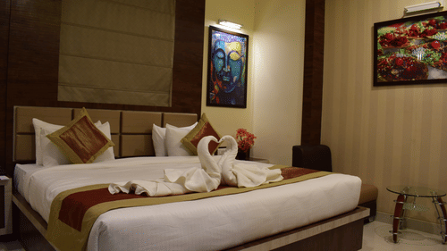 A stylish and comfortable bedroom with modern decor at Hotel Uday Palace, offering premium rooms in Varanasi.