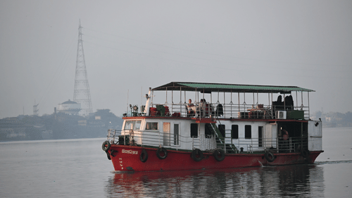 Passenger boat cruising across calm waters during the early morning.