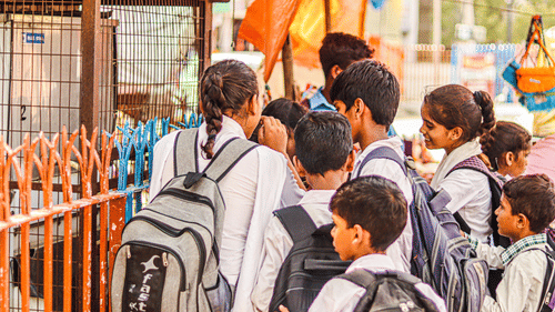 School children gathered near a ticket counter during an educational outing.
