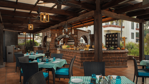 Salute, an Italian restaurant with its outdoor seating facility in view at Kenilworth REsort & Spa, Goa.