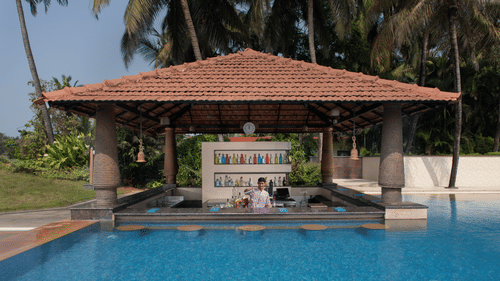 Aquarius, a pool-side cafe in South Goa, looks dream-like as it resembles a gazebo coming out of the pool in a lush green backdrop