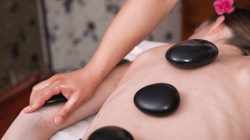 A woman getting a hot stone treatment done