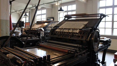 An image of an old printing machine inside a building