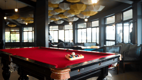 A pool table placed in a spacious room - Polo Cherrapunjee Resort