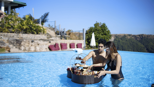 two people eating from a tray inside the pool - Polo Cherrapunjee Resort