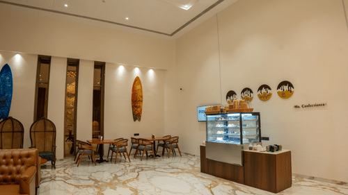 Image of confectionery with seating area and sweet treats on display at Pride Elite Daman.