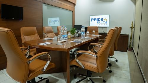 Image of conference room with eight chairs and a table at Pride Elite Daman.