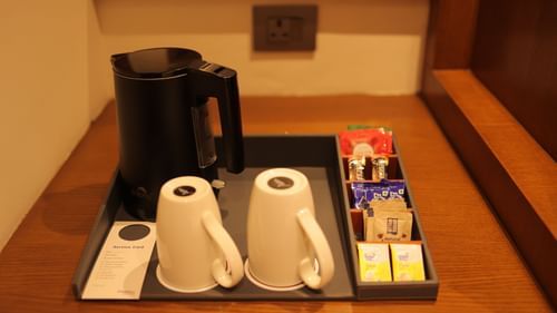 a tray of tea and coffee maker