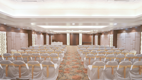Theatre-style event hall at Rivera Sarovar Portico, Ahmedabad showcasing neatly arranged seating, elegant décor and spacious interiors for conferences.