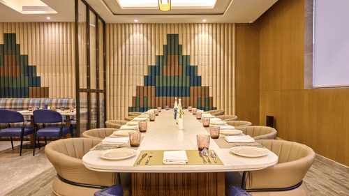 Private dining room at Riviera Sarovar Portico, Pathankot with a long table setup, ideal for business meals and small group gatherings.