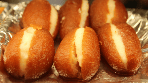 Shallow brown roasted Gulab Jamun dipped in sugar syrup